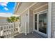 Condo entrance featuring a private balcony, gray siding, and a glimpse of tropical palm trees at 7490 Palm Island Dr # 2324, Placida, FL 33946