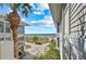 View of a condo exterior with balcony and beach views amidst lush tropical foliage and blue skies at 7490 Palm Island Dr # 2324, Placida, FL 33946