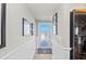 Light-filled condo hallway with wainscoting, art, and a view to the outside at 7490 Palm Island Dr # 2324, Placida, FL 33946