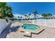 Relaxing hot tub near community pool, set against a backdrop of lush palm trees under a bright blue sky at 7490 Palm Island Dr # 2324, Placida, FL 33946