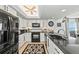 Bright kitchen featuring white cabinets, black appliances, granite counters, with a view of the dining area at 7490 Palm Island Dr # 2324, Placida, FL 33946