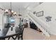 Bright and open living space with stairs, dining area and a glimpse into the kitchen at 7490 Palm Island Dr # 2324, Placida, FL 33946