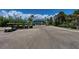 View of golf carts parked near a property under a beautiful blue sky with palm trees at 7490 Palm Island Dr # 2324, Placida, FL 33946