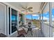 Relax on the screened patio with comfortable seating and stunning beach views at 7490 Palm Island Dr # 2324, Placida, FL 33946