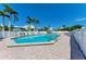Beautiful community pool surrounded by lush tropical landscaping, lounge chairs, and bright blue water at 7490 Palm Island Dr # 2324, Placida, FL 33946
