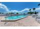 View of large pool with lounge chairs and shade umbrellas in brick pool area at 7490 Palm Island Dr # 2324, Placida, FL 33946