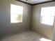 This is an empty bedroom with tile flooring and natural lighting at 7954 Jeffery Ave, North Port, FL 34287