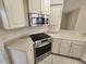 Modern kitchen with stainless steel appliances and white cabinetry at 8323 Eagle Isle Pl, Bradenton, FL 34212