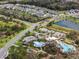 Aerial view showcasing community amenities: pool, splash pad, playground, parking, and surrounding homes at 8619 Firefly Pl, Parrish, FL 34219