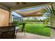 Comfortable back patio with a sun shade, perfect for outdoor dining and relaxation at 8619 Firefly Pl, Parrish, FL 34219