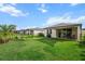 Spacious backyard with lush lawn, black fence, patio and sunshade sail at 8619 Firefly Pl, Parrish, FL 34219