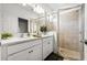 Modern bathroom featuring a dual sink vanity, a frameless glass shower and sleek fixtures at 8619 Firefly Pl, Parrish, FL 34219