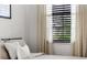 Close-up of bedroom showing window with blinds and light filtering curtains at 8619 Firefly Pl, Parrish, FL 34219