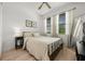 Bright bedroom featuring wood-look floors, neutral decor, and ample natural light at 8619 Firefly Pl, Parrish, FL 34219
