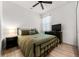 Bedroom features a queen bed, dark wood furniture, ceiling fan and neutral walls at 8619 Firefly Pl, Parrish, FL 34219