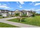 Single Gathering home with a manicured lawn, attached garage, and verdant landscaping on a beautiful day at 8619 Firefly Pl, Parrish, FL 34219