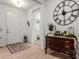 Inviting foyer features a decorative wall clock and neutral color palette at 8619 Firefly Pl, Parrish, FL 34219