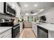 Open kitchen featuring stainless appliances, a tile backsplash, and a view into the living area at 8619 Firefly Pl, Parrish, FL 34219