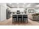 Modern kitchen featuring stainless steel appliances, white cabinets, and an island with bar seating at 8619 Firefly Pl, Parrish, FL 34219