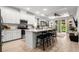 Bright, modern kitchen with white cabinets, stainless steel appliances, and a large center island at 8619 Firefly Pl, Parrish, FL 34219