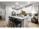 Bright kitchen with white cabinets, a large center island, and a view into the dining area at 8619 Firefly Pl, Parrish, FL 34219