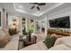 Spacious living area with comfortable seating, a ceiling fan, and a seamless flow to the outdoors at 8619 Firefly Pl, Parrish, FL 34219