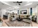 Open-concept living room with views of the kitchen, comfortable seating, and a stylish rug at 8619 Firefly Pl, Parrish, FL 34219