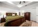 Comfortable main bedroom featuring a tray ceiling, and neutral decor at 8619 Firefly Pl, Parrish, FL 34219