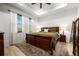 Serene main bedroom showcasing a tray ceiling and natural light, with a cozy rug at 8619 Firefly Pl, Parrish, FL 34219