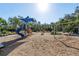 Summerwoods community playground with swings, slide, and other equipment on wood chips at 8619 Firefly Pl, Parrish, FL 34219