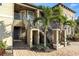 Multi-story building exterior featuring iron railings, palm trees, and brick walkway at 12720 Sorrento Way # 102, Bradenton, FL 34211