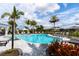 Inviting community pool with comfortable lounge chairs and shaded umbrellas at 12720 Sorrento Way # 102, Bradenton, FL 34211