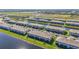 An aerial view of a townhome community featuring well-manicured lawns and lakeside living at 15147 Sunny Day Dr, Bradenton, FL 34211