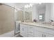 Modern bathroom featuring granite countertops, dual sinks, and a glass-enclosed shower at 15147 Sunny Day Dr, Bradenton, FL 34211