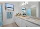 Bathroom with single sink vanity, granite counters and decorative accents at 15147 Sunny Day Dr, Bradenton, FL 34211
