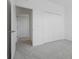Bedroom features soft carpet, closet and doorway to hall at 15147 Sunny Day Dr, Bradenton, FL 34211