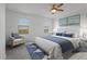 Serene bedroom with a ceiling fan, plush bedding, and soothing blue accents at 15147 Sunny Day Dr, Bradenton, FL 34211