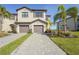 Elegant two-story townhome with a private two-car garage and a well-manicured lawn and beautiful walkway at 15147 Sunny Day Dr, Bradenton, FL 34211