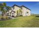 Charming townhouse featuring a two-car garage, lush landscaping, and a well-maintained lawn at 15147 Sunny Day Dr, Bradenton, FL 34211