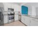 Contemporary kitchen with stainless steel appliances, white cabinets, and granite countertops at 15147 Sunny Day Dr, Bradenton, FL 34211