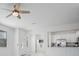 Open-concept living space with white walls, large window, and a partial view of the kitchen at 15147 Sunny Day Dr, Bradenton, FL 34211