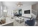 Bright and airy living room with modern decor, including a plush sofa and marble-topped coffee table at 15147 Sunny Day Dr, Bradenton, FL 34211