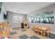 Bright playroom with toys, a playhouse, and a mirror wall for observation at 15147 Sunny Day Dr, Bradenton, FL 34211
