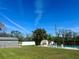 Expansive backyard featuring a well-maintained lawn, pool area, and storage shed at 1518 49Th E St, Palmetto, FL 34221