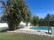 Beautiful pool area complemented by mature palm trees and a charming bench at 1518 49Th E St, Palmetto, FL 34221