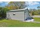 Spacious gray metal shed with roll-up door, next to a picnic table at 1518 49Th E St, Palmetto, FL 34221