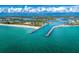 Expansive aerial view of the harbor with turquoise water, beaches, and residential areas in the distance at 1604 Still River Dr, Venice, FL 34293