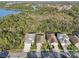 Aerial view highlighting the home's position near a lake and lush greenery at 1604 Still River Dr, Venice, FL 34293