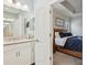 Bathroom featuring white cabinetry, modern fixtures, and an open doorway into the main bedroom at 1604 Still River Dr, Venice, FL 34293