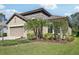 Beautiful home featuring a tile roof, manicured landscaping, and neutral paint scheme at 1604 Still River Dr, Venice, FL 34293